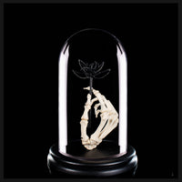 Real human skeleton hand holding black bone flower
